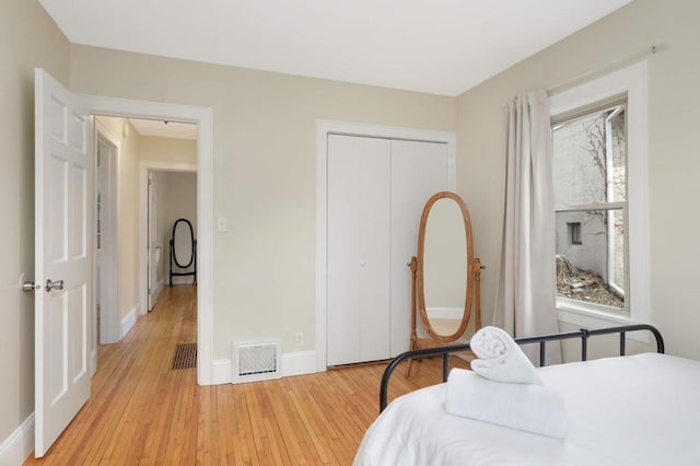 1750 Sims Ave, Saint Paul, MN 55106 - bedroom featuring light wood-style flooring, baseboards, and a closet