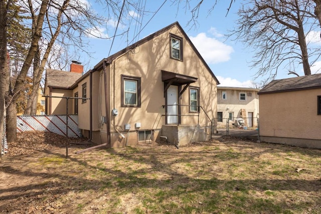 1750 Sims Ave, Saint Paul, MN 55106 - back of house with stucco siding and a chimney