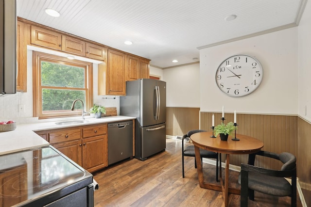 218 Owens St N, Stillwater, MN 55082 - kitchen with a sink, appliances with stainless steel finishes, a wainscoted wall, brown cabinets, and light countertops