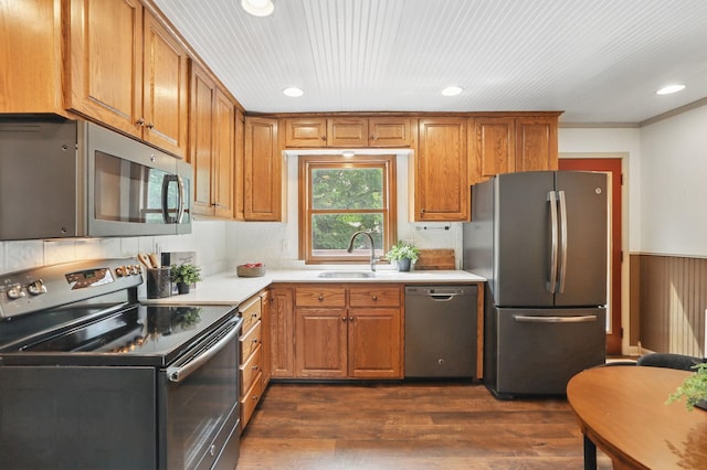 218 Owens St N, Stillwater, MN 55082 - kitchen featuring appliances with stainless steel finishes, a sink, recessed lighting, brown cabinetry, and dark wood finished floors