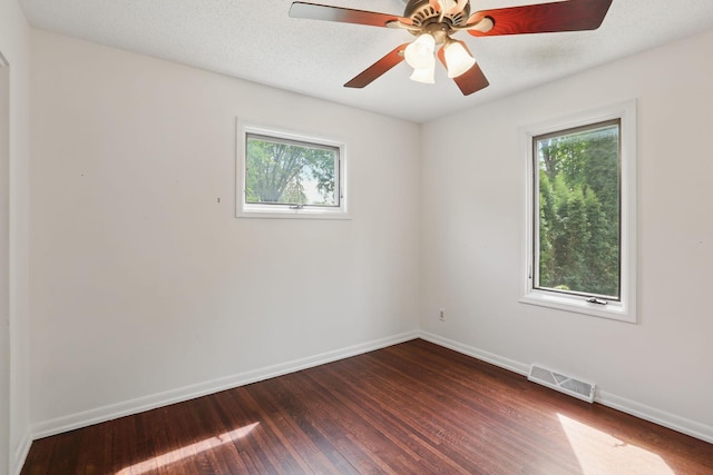 218 Owens St N, Stillwater, MN 55082 - empty room with healthy amount of natural light, dark wood finished floors, and baseboards