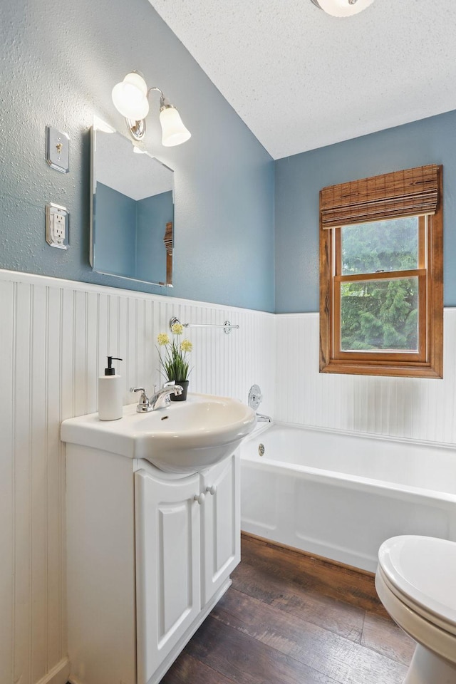 218 Owens St N, Stillwater, MN 55082 - full bath featuring wainscoting, wood finished floors, a garden tub, vanity, and toilet