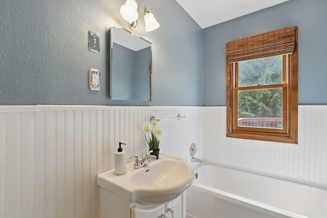 218 Owens St N, Stillwater, MN 55082 - full bathroom featuring a wainscoted wall, a bath, and vanity