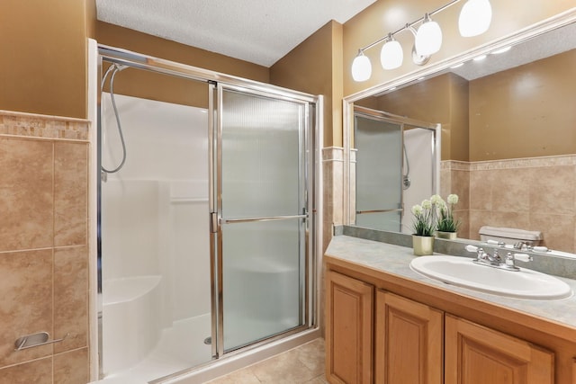 218 Owens St N, Stillwater, MN 55082 - full bath with tile walls, a stall shower, tile patterned floors, vanity, and wainscoting