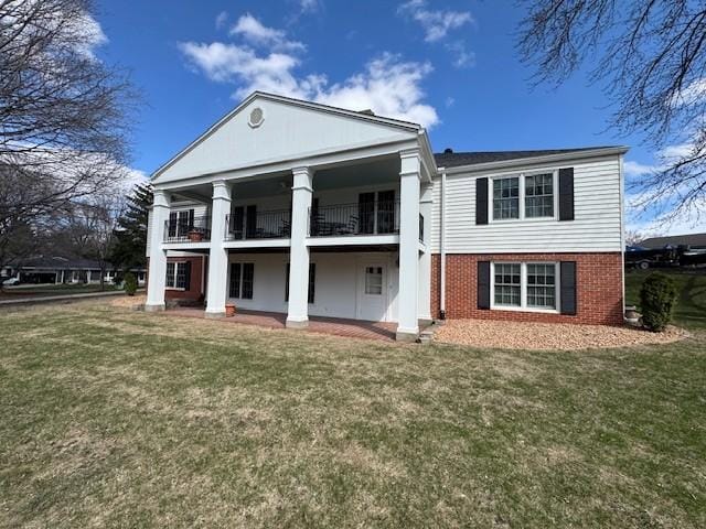 331 Willamor Cir, Albert Lea, MN 56007 - rear view of house with a balcony, a yard, and brick siding