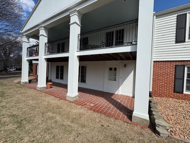 331 Willamor Cir, Albert Lea, MN 56007 - rear view of house with a balcony and a patio