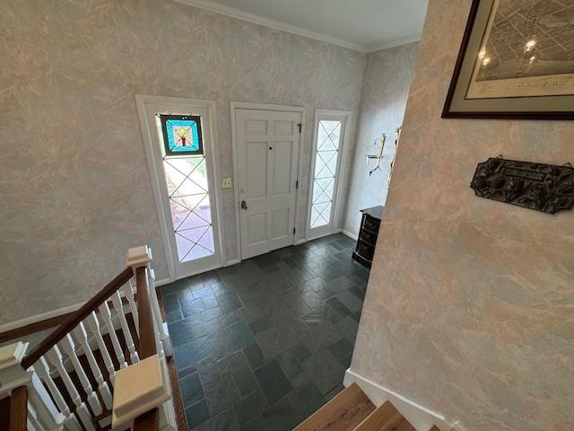 331 Willamor Cir, Albert Lea, MN 56007 - entrance foyer with stone tile flooring, ornamental molding, healthy amount of natural light, and wallpapered walls