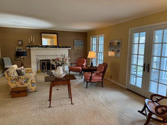 331 Willamor Cir, Albert Lea, MN 56007 - carpeted living room featuring french doors, crown molding, a glass covered fireplace, and baseboards