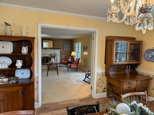 331 Willamor Cir, Albert Lea, MN 56007 - dining space featuring a chandelier, ornamental molding, wood finished floors, and baseboards