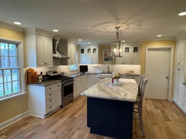 331 Willamor Cir, Albert Lea, MN 56007 - kitchen featuring wall chimney range hood, gas stove, a sink, recessed lighting, and backsplash
