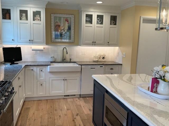331 Willamor Cir, Albert Lea, MN 56007 - kitchen featuring white dishwasher, a sink, range, light wood finished floors, and white cabinets