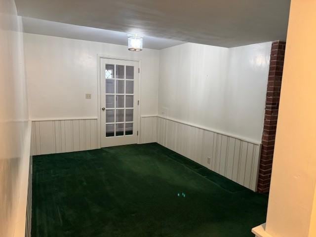331 Willamor Cir, Albert Lea, MN 56007 - unfurnished room with wainscoting and dark carpet