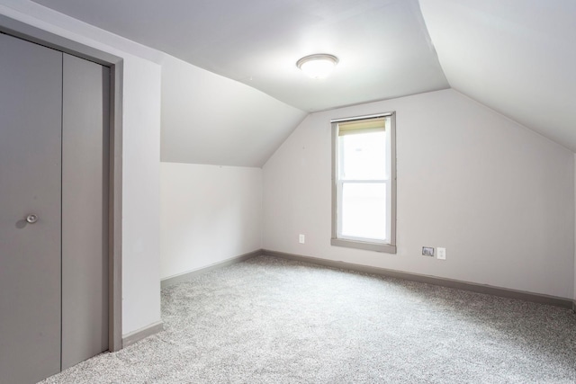 428 4th St, River Falls, WI 54022 - bonus room with vaulted ceiling, carpet flooring, and baseboards