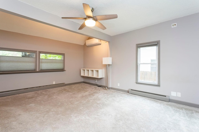 428 4th St, River Falls, WI 54022 - empty room with baseboard heating, a wall unit AC, plenty of natural light, and lofted ceiling