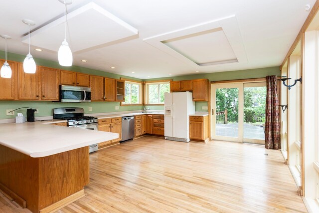 428 4th St, River Falls, WI 54022 - kitchen featuring appliances with stainless steel finishes, a sink, plenty of natural light, brown cabinets, and recessed lighting