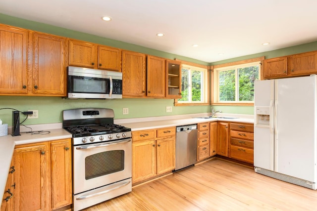428 4th St, River Falls, WI 54022 - kitchen featuring appliances with stainless steel finishes, a sink, light countertops, recessed lighting, and light wood-style flooring