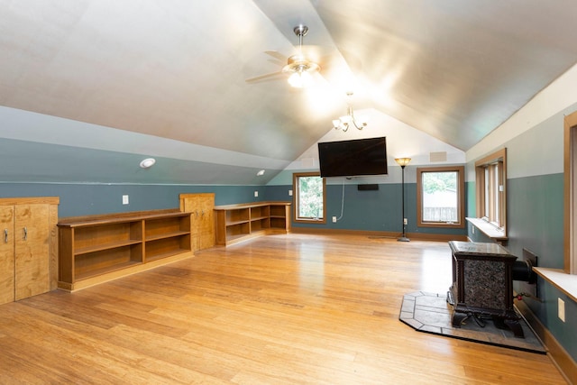 428 4th St, River Falls, WI 54022 - bonus room with a wood stove, wood finished floors, vaulted ceiling, and ceiling fan