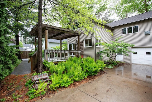428 4th St, River Falls, WI 54022 - view of property exterior with a pergola, a deck, driveway, and an attached garage