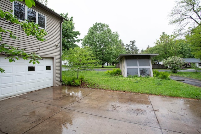 428 4th St, River Falls, WI 54022 - garage with concrete driveway and a shed