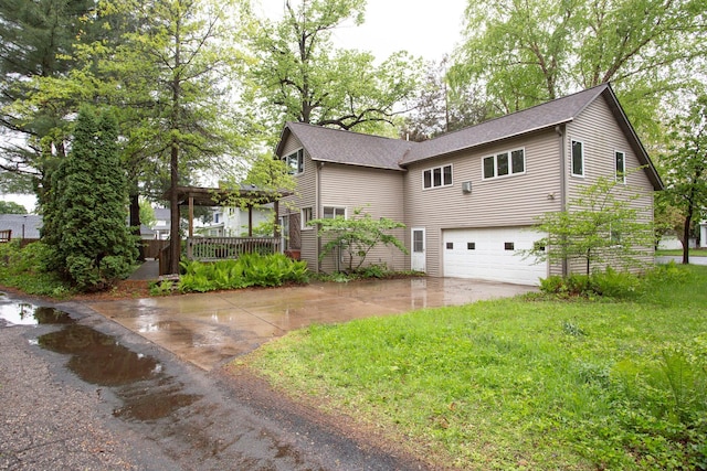 428 4th St, River Falls, WI 54022 - view of front facade featuring an attached garage, concrete driveway, and roof with shingles