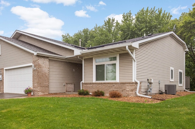 842 Monet Ct, Mendota Heights, MN 55120 - view of front of home featuring a front yard, brick siding, an attached garage, and central AC unit