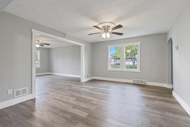 806 4th St, Marshall, MN 56258 - unfurnished room featuring arched walkways, a ceiling fan, and healthy amount of natural light
