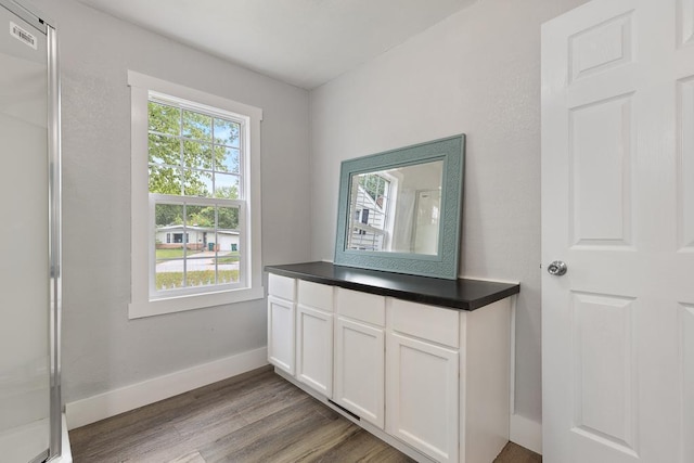 806 4th St, Marshall, MN 56258 - detailed view of wood finished floors, baseboards, and fridge