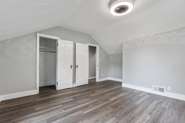 806 4th St, Marshall, MN 56258 - additional living space with dark wood-style floors, vaulted ceiling, and baseboards