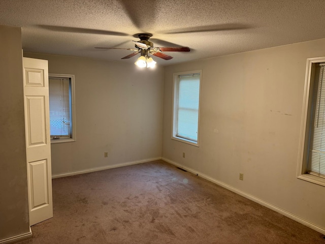 605 Division St W, Faribault, MN 55021 - empty room featuring ceiling fan, carpet floors, a textured ceiling, and baseboards