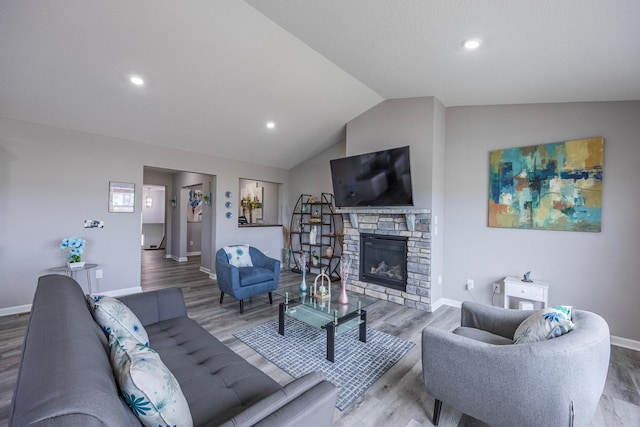 4329 141st Ln NW, Andover, MN 55304 - living area with wood finished floors, vaulted ceiling, baseboards, a stone fireplace, and recessed lighting