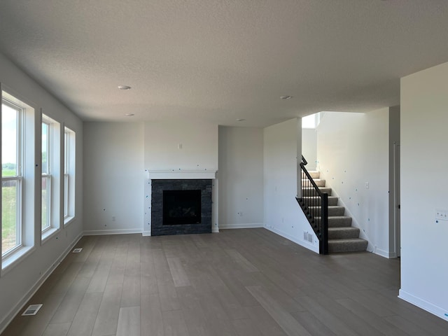 2719 Aspen Dr, Shakopee, MN 55379 - unfurnished living room featuring stairs, dark wood finished floors, a textured ceiling, and baseboards