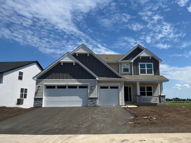 2719 Aspen Dr, Shakopee, MN 55379 - craftsman inspired home featuring board and batten siding, asphalt driveway, a porch, a garage, and stone siding