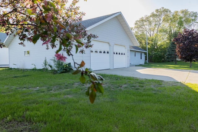 101 6th St NW, Perham, MN 56573 - view of side of property featuring a yard, a garage, roof with shingles, and driveway