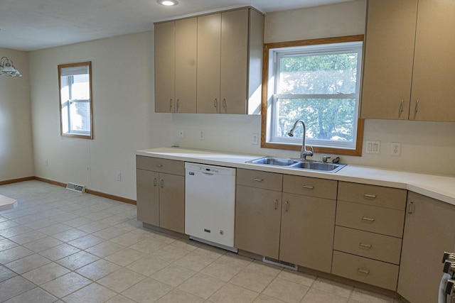 101 6th St NW, Perham, MN 56573 - kitchen featuring white dishwasher, a sink, light countertops, baseboards, and gray cabinets