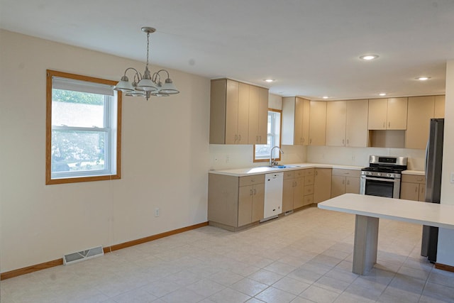101 6th St NW, Perham, MN 56573 - kitchen featuring appliances with stainless steel finishes, a sink, light countertops, a chandelier, and recessed lighting