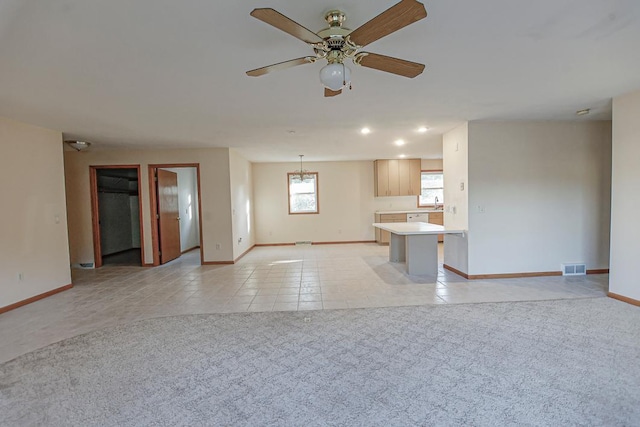 101 6th St NW, Perham, MN 56573 - unfurnished living room featuring baseboards, light carpet, light tile patterned flooring, ceiling fan, and recessed lighting