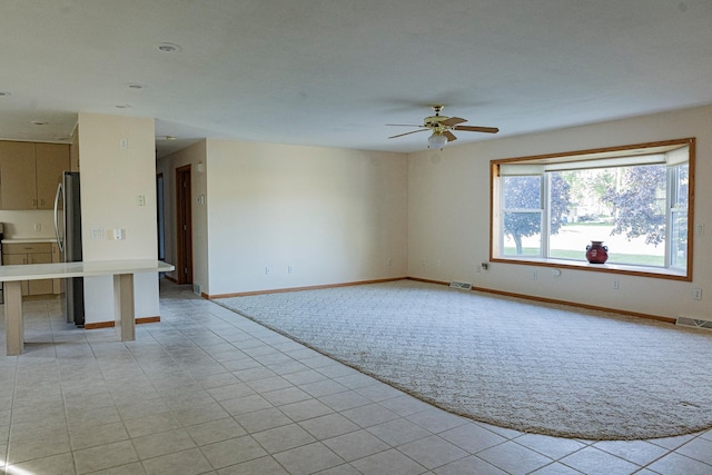 101 6th St NW, Perham, MN 56573 - unfurnished living room with ceiling fan, baseboards, and light tile patterned flooring