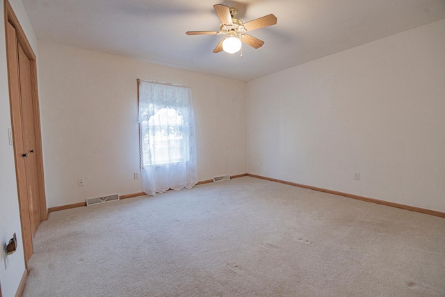 101 6th St NW, Perham, MN 56573 - empty room featuring light colored carpet, a ceiling fan, and baseboards