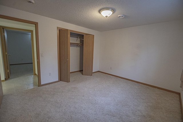 101 6th St NW, Perham, MN 56573 - unfurnished bedroom featuring light colored carpet, a closet, baseboards, and a textured ceiling