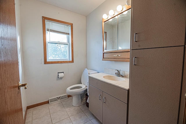 101 6th St NW, Perham, MN 56573 - bathroom with baseboards, toilet, vanity, and tile patterned flooring
