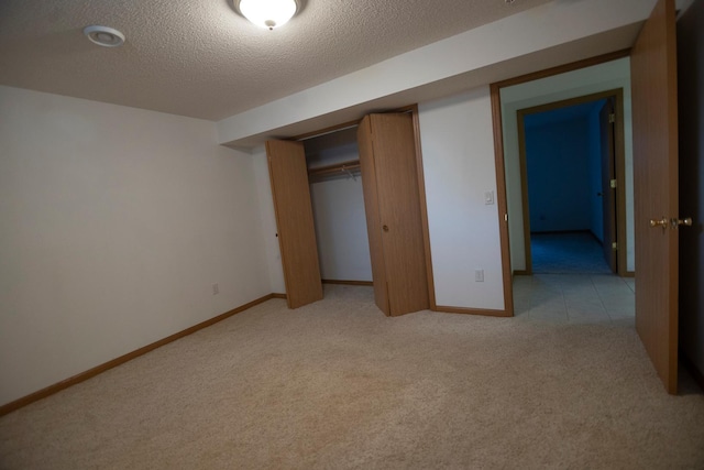 101 6th St NW, Perham, MN 56573 - unfurnished bedroom featuring light colored carpet, a textured ceiling, baseboards, and a closet