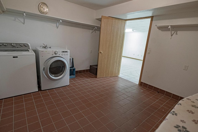 101 6th St NW, Perham, MN 56573 - washroom with washer and clothes dryer and dark tile patterned floors