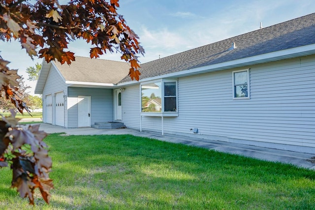 101 6th St NW, Perham, MN 56573 - rear view of house featuring a lawn, a garage, and a shingled roof