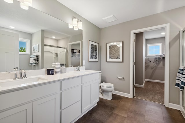 15242 Nutria St NW, Ramsey, MN 55303 - bathroom featuring a shower stall, a spacious closet, toilet, and recessed lighting