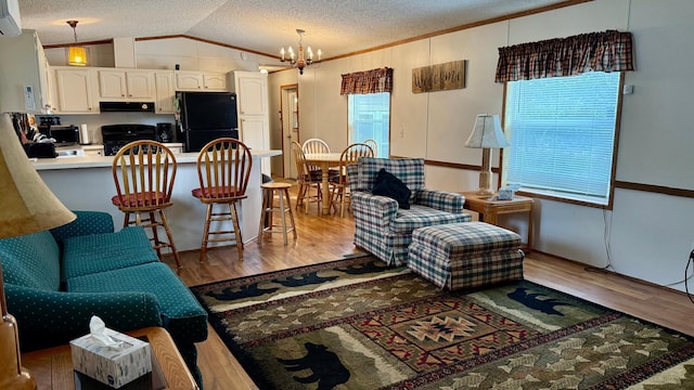 25673 Happy Hollow Rd, Park Rapids, MN 56470 - living room with vaulted ceiling, a chandelier, wood finished floors, a textured ceiling, and crown molding