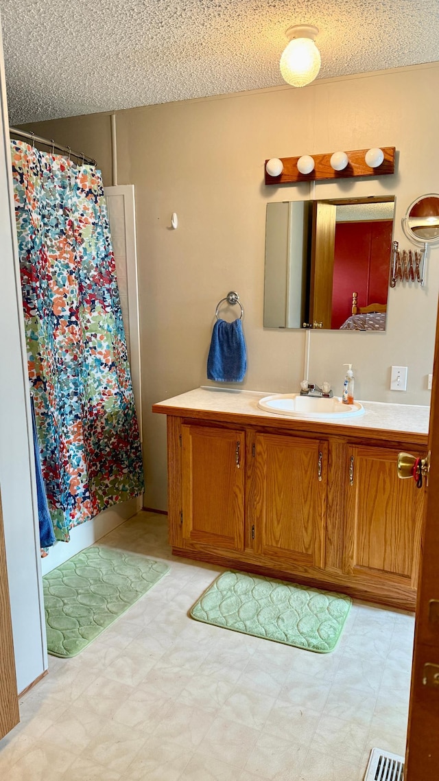 25673 Happy Hollow Rd, Park Rapids, MN 56470 - bathroom with a textured ceiling, tile patterned floors, vanity, and curtained shower