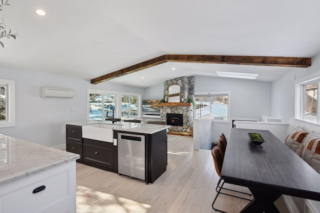 168 1st St, Excelsior, MN 55331 - kitchen featuring stainless steel dishwasher, a sink, a wall mounted air conditioner, healthy amount of natural light, and recessed lighting