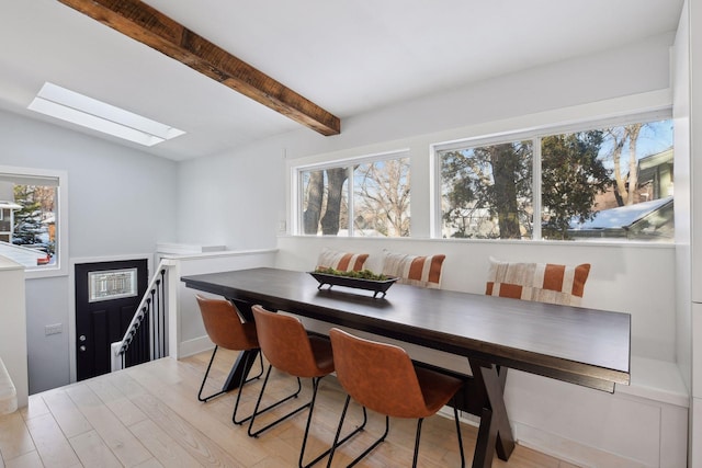 168 1st St, Excelsior, MN 55331 - dining area with a skylight, beamed ceiling, and light wood finished floors