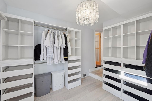 168 1st St, Excelsior, MN 55331 - spacious closet with wood finished floors and a chandelier