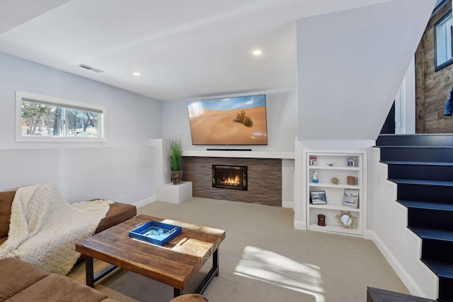 168 1st St, Excelsior, MN 55331 - carpeted living area with a lit fireplace, baseboards, recessed lighting, and built in shelves